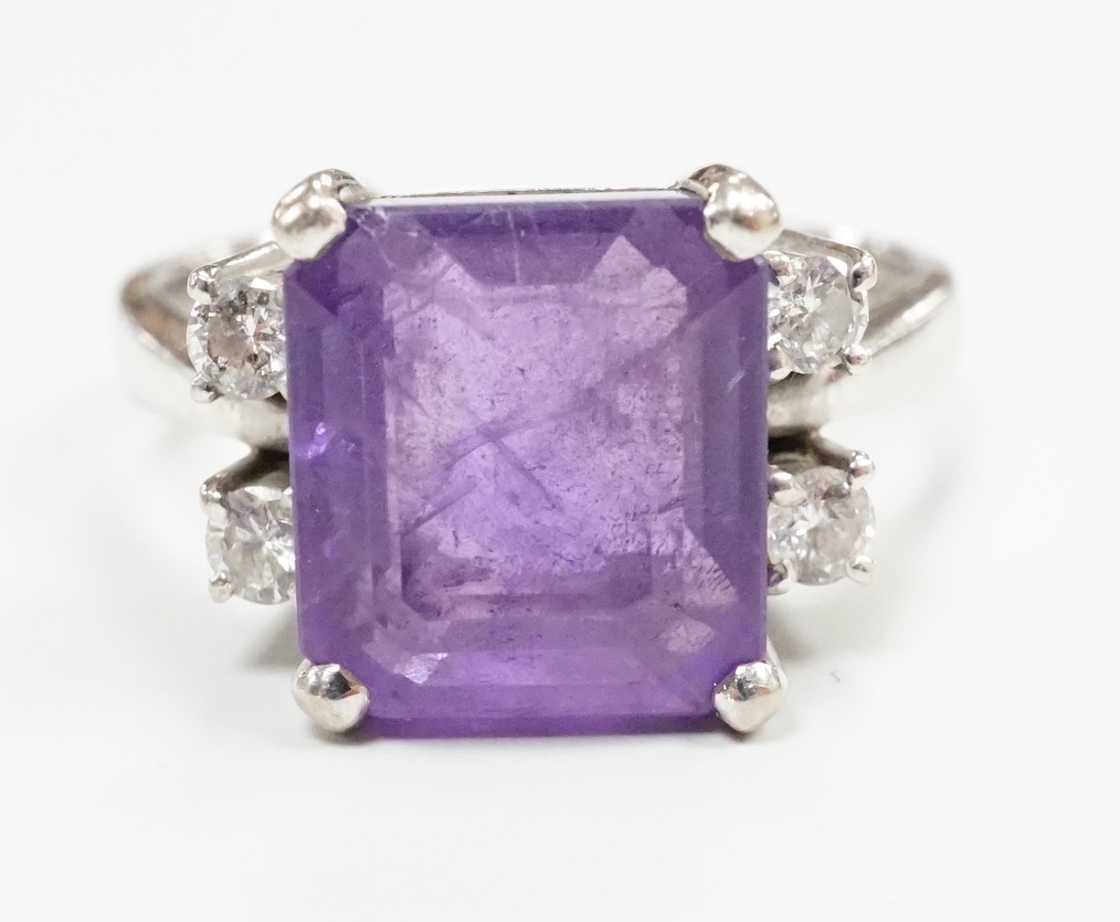 A modern 585 white metal single stone amethyst and four stone diamond set dress ring, size S/T, gross weight 8.1 grams.